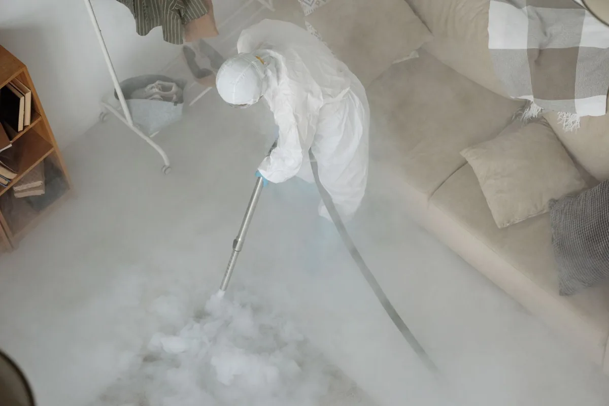 Biohazard cleanup technician in protective equipment, Clayton, NM